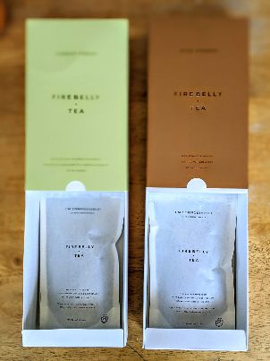 open boxes and showing pouches of firebelly tea